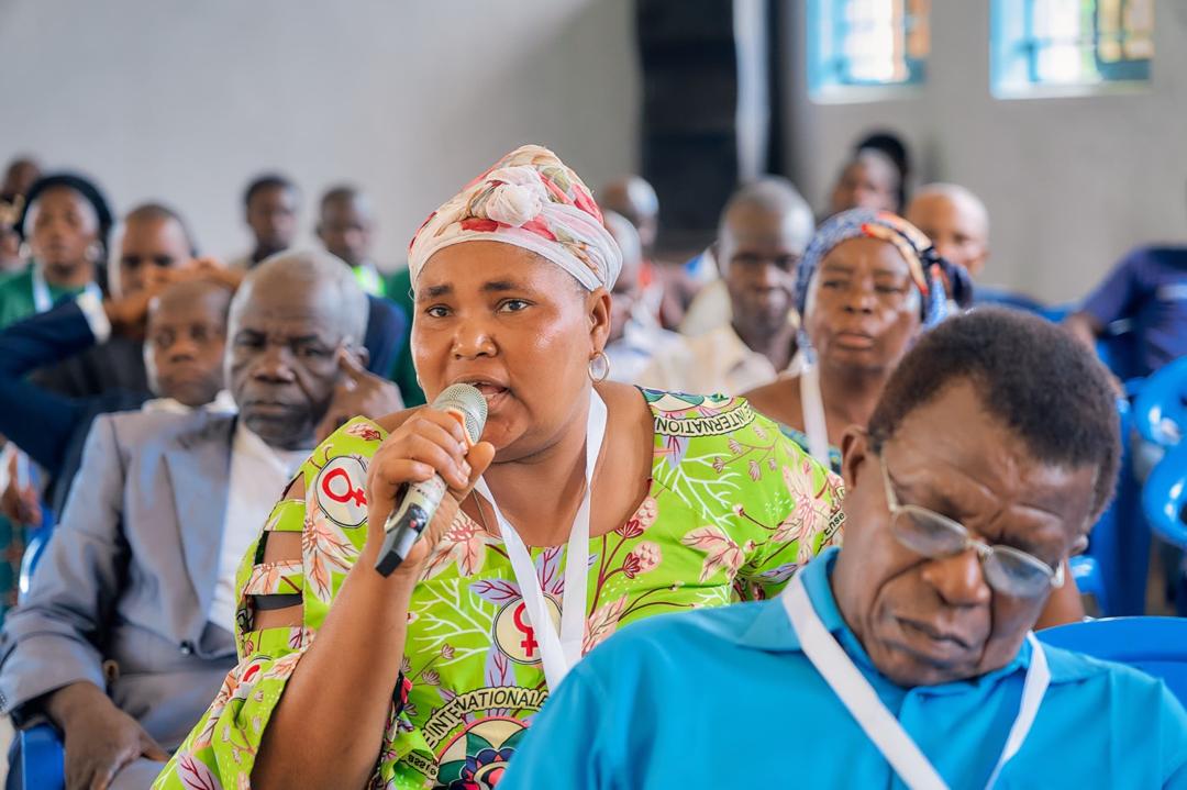 Community members gathered together in a village in the Democratic Republic of Congo